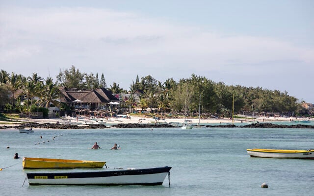 Beachgoers and tourists enjoy the sea near a private resort in Trou d’Eau Douce, Mauritius on January 7, 2024. (Gianluigi Guercia/AFP)