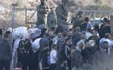 Israeli soldiers stop Palestinian farmers from Salem village at a checkpoint before entering through a closed gate onto their land to pick olives, east of Nablus in the West Bank, on November 22, 2025. (Jaafar ASHTIYEH/AFP)