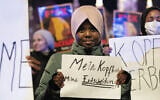 Hadiya, an 11-year old student, holds a sign that reads, in German, 'My head, my decision,' during a protest against the Austrian headscarf ban in schools, in Vienna, Austriam on February 13, 2026. (Joe Klamar/AFP)