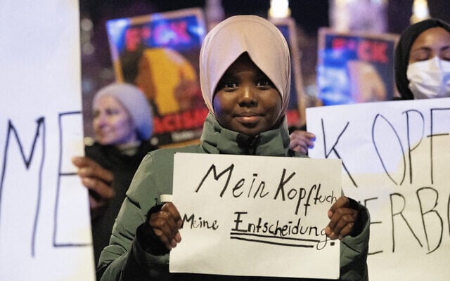 Hadiya, an 11-year old student, holds a sign that reads, in German, 'My head, my decision,' during a protest against the Austrian headscarf ban in schools, in Vienna, Austriam on February 13, 2026. (Joe Klamar/AFP) Hadiya, an 11-year old student, holds a sign that reads, in German, 'My head, my decision,' during a protest against the Austrian headscarf ban in schools, in Vienna, Austriam on February 13, 2026. (Joe Klamar/AFP)