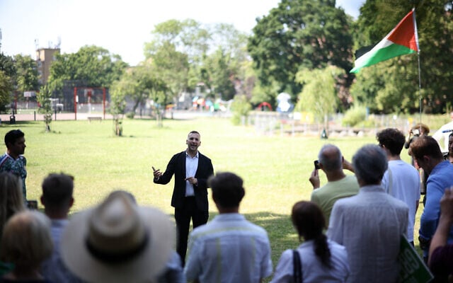 Britain’s leader of the Green Party, Zack Polanski, addresses supporters, one of whom is holding a Palestinian flag, during a rally in south London, on June 24, 2026. (Henry NICHOLLS/AFP) Britain’s leader of the Green Party, Zack Polanski, addresses supporters, one of whom is holding a Palestinian flag, during a rally in south London, on June 24, 2026. (Henry NICHOLLS/AFP)