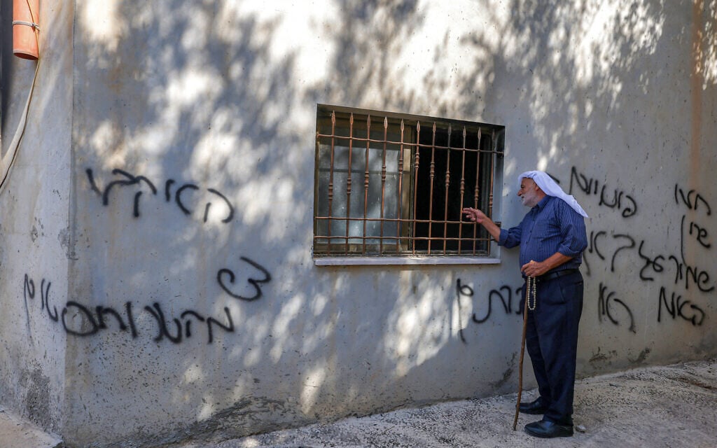 A man stands by Hebrew graffiti left by Israeli settlers following a reported arson attack on a mosque in the Palestinian village of Bazzaryah, in the West Bank, on September 1, 2026. (JAAFAR ASHTIYEH/AFP) A man stands by Hebrew graffiti left by Israeli settlers following a reported arson attack on a mosque in the Palestinian village of Bazzaryah, in the West Bank, on September 1, 2026. (JAAFAR ASHTIYEH/AFP)