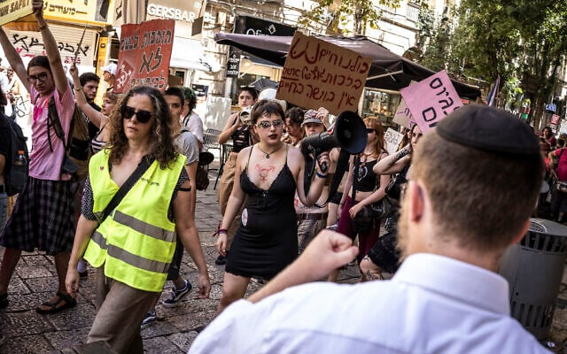 A man shouts at demonstrators holding up placards and chanting during the annual ‘SlutWalk’, against firearms in public and private spaces and against the rape culture and violence against women, in Jerusalem on September 4, 2026. (JOHN WESSELS/AFP)
