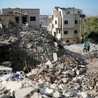 Residents inspect the damage after an overnight airstrike by the Israeli military that targeted Hezbollah in the southern Lebanese village of Mayfadoun on September 5, 2026. (ammar ammar/AFP)
