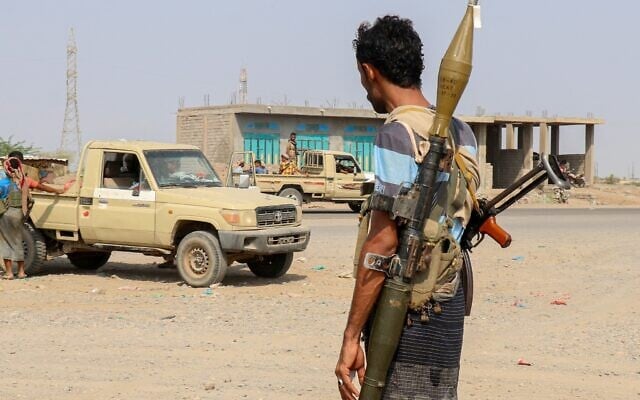 Forces loyal to Yemen’s Saudi-backed government stand near a pick-up truck in the Hays district, south of Hodeidah, September 5, 2026. (Khaled ZIAD/AFP)