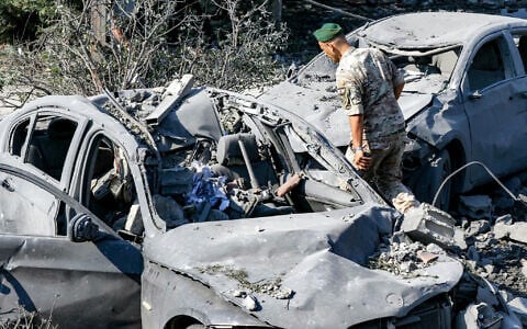 A Lebanese army soldier inspects destroyed vehicles at the site of an overnight Israeli airstrike on the village of Kfar Roummane in southern Lebanon on September 7, 2026. (MAHMOUD ZAYYAT/AFP)