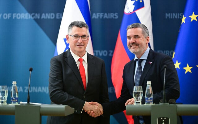 Slovenia’s Foreign Minister Tone Kajzer (R) and Israel’s Foreign Minister Gideon Sa'ar (L) shake hands during a joint press conference prior to the opening of Israel’s embassy in Slovenia, in Ljubljana on September 9, 2026. (Martin Metelko/AFP)