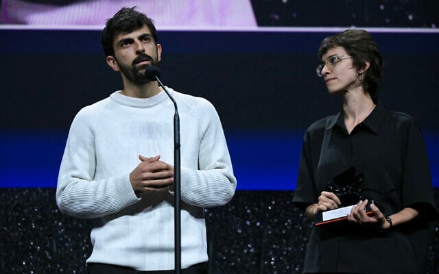 Israeli journalist Yuval Abraham, left, speaks as he and his co-director Rachel Szor accept the Special Jury Prize for 'NAZA' during the closing ceremony of the 83rd Venice Film Festival at Venice Lido, Italy, on September 12, 2026. (Stefano Rellandini/AFP)