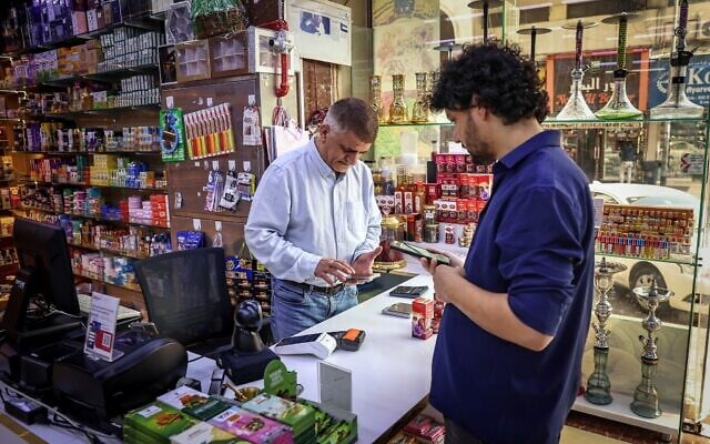 Iranian shop owner Morteza Asaadi (L) attends to a customer at his shop in downtown Bur Dubai on September 3, 2026. (Fadel Senna/AFP) Iranian shop owner Morteza Asaadi (L) attends to a customer at his shop in downtown Bur Dubai on September 3, 2026. (Fadel Senna/AFP)