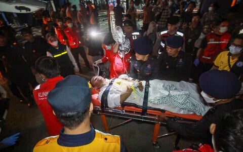Rescue teams evacuate a victim of a passenger ferry that capsized while carrying 243 people on its route to Banjarmasin from Surabaya, Indonesia, on September 13, 2026. (INFUZ/AFP)