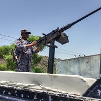 A member of the Saudi-backed Yemeni government forces, including National Army and Taiz Axis forces, mans a turret mounted on the back of a pickup truck at a checkpoint along the Kadha frontline west of Taiz in western Yemen, on September 13, 2026. (AFP)