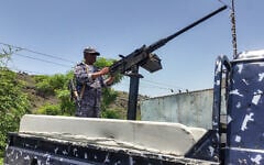 A member of the Saudi-backed Yemeni government forces, including National Army and Taiz Axis forces, mans a turret mounted on the back of a pickup truck at a checkpoint along the Kadha frontline west of Taiz in western Yemen, on September 13, 2026. (AFP)