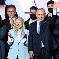Prime Minister Benjamin Netanyahu, 2nd right, waves next to his wife Sara, 2nd left, as they stand on stage with Likud party lawmakers and ministers during a campaign event in Tel Aviv on September 17, 2026. (Jack GUEZ/AFP)