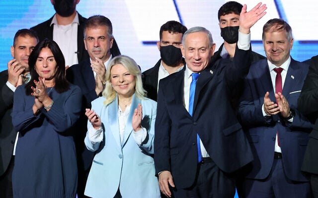 Prime Minister Benjamin Netanyahu, 2nd right, waves next to his wife Sara, 2nd left, as they stand on stage with Likud party lawmakers and ministers during a campaign event in Tel Aviv on September 17, 2026. (Jack GUEZ/AFP)