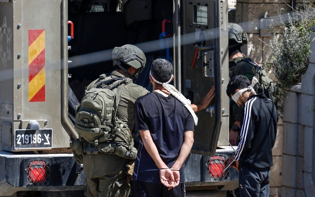 Blindfolded Palestinian men, who were arrested during a raid by Israeli forces, prepare to board a vehicle in the Palestinian village of Biddu, northwest of Jerusalem on September 21, 2026. (Zain Jaafar/AFP) Blindfolded Palestinian men, who were arrested during a raid by Israeli forces, prepare to board a vehicle in the Palestinian village of Biddu, northwest of Jerusalem on September 21, 2026. (Zain Jaafar/AFP)
