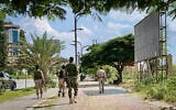 Members of the Tigray People’s Liberation Front (TPLF) walk along a main road in Mekelle on September 23, 2026, as tensions intensify in northern Ethiopia after Tigrayan rebels seized control of airports in the region. (AFP)