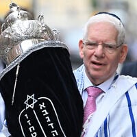 The President of the Central Council of Jews in Germany, Josef Schuster, carries the Torah scroll during the inauguration ceremony of the rooms of the first military rabbinate of the German Armed Forces Bundeswehr in Berlin, Germany, on July 4, 2024. (RALF HIRSCHBERGER/AFP/File)