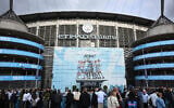 Fans arrive outside the Etihad Stadium ahead of the UEFA Champions League second leg semi-final football match between Manchester City and Real Madrid in Manchester, north west England, on May 17, 2023. (Paul ELLIS/AFP)