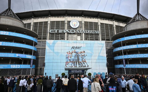 Fans arrive outside the Etihad Stadium ahead of the UEFA Champions League second leg semi-final football match between Manchester City and Real Madrid in Manchester, north west England, on May 17, 2023. (Paul ELLIS/AFP)