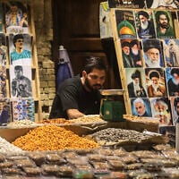 An Iraqi man selling photographs sits at his stall on Al-Mutanabbi Street in Baghdad’s Al-Maidan central district on September 28, 2026. (AHMAD AL-RUBAYE/AFP)