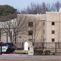 Police gather in front of the Congregation Beth Israel synagogue, January 16, 2022, in Colleyville, Texas, a day after four were taken hostage by a pistol-wielding man during a Shabbat service. (AP Photo/Brandon Wade)