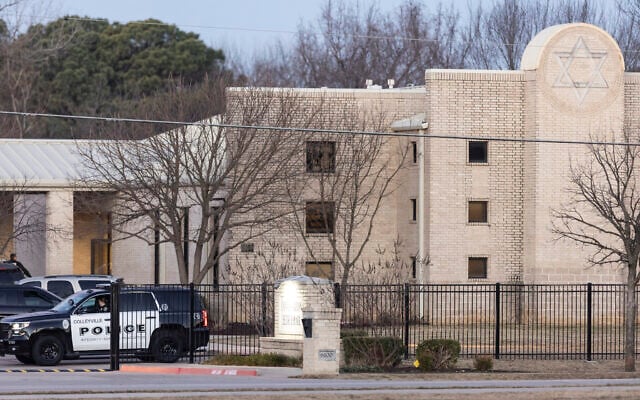 Police gather in front of the Congregation Beth Israel synagogue, January 16, 2022, in Colleyville, Texas, a day after four were taken hostage by a pistol-wielding man during a Shabbat service. (AP Photo/Brandon Wade)