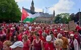 Tens of thousands of red-clad protesters marched past the Peace Palace, housing the International Court of Justice, rear, demanding their government do more to halt Israel's campaign in Gaza, during a demonstration in The Hague, Netherlands, Sunday, June 15, 2025. (AP Photo/Peter Dejong)