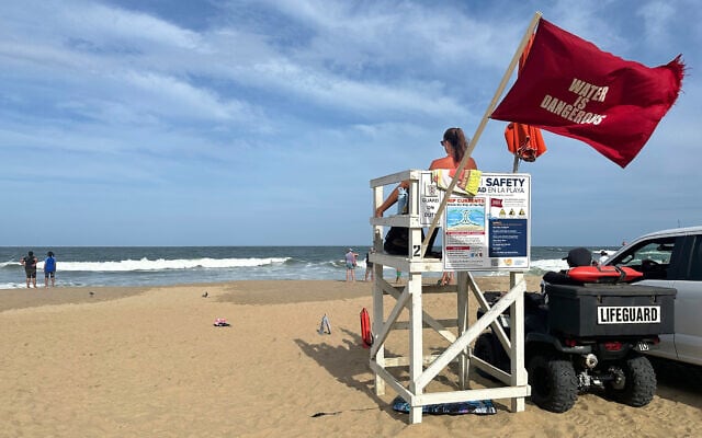 A lifeguard keeps watch along the Atlantic Ocean in Virginia Beach, Virginia, on August 20, 2025. (AP Photo/Ben Finley)