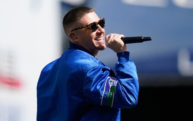 Rap singer Macklemore performs before an NFL football game between the Seattle Seahawks and the Tennessee Titans, September 19, 2021, in Seattle, Washington. (AP Photo/ Elaine Thompson/ File)