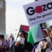 File: Demonstrators hold placards and banners during a pro Palestinian protest as they march through central London, October 11, 2025. (AP Photo/Joanna Chan)