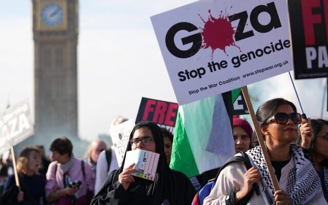 File: Demonstrators hold placards and banners during a pro Palestinian protest as they march through central London, October 11, 2025. (AP Photo/Joanna Chan)
