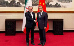 Iranian Foreign Minister Abbas Araghchi, left, shakes hands with his Chinese counterpart Wang Yi in Beijing, China, on May 6, 2026. (Telegram channel of the Iranian Foreign Minister via AP)