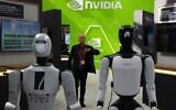 A worker stands near robots at the Nvidia booth during the China International Supply Chain Expo in Beijing on June 22, 2026. (Ng Han Guan/AP)