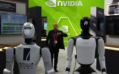 A worker stands near robots at the Nvidia booth during the China International Supply Chain Expo in Beijing on June 22, 2026. (Ng Han Guan/AP)