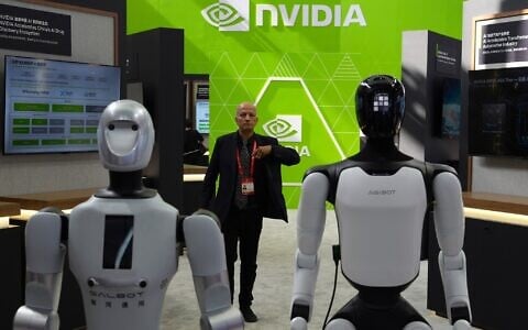 A worker stands near robots at the Nvidia booth during the China International Supply Chain Expo in Beijing on June 22, 2026. (Ng Han Guan/AP)