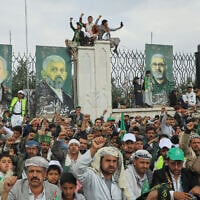 Houthi supporters shout slogans in front of posters showing from right to left; late Iranian IRGC commander Qasem Soleimani, deputy commander of the Popular Mobilization Forces, Abu Mahdi al-Muhandis, late Hamas leaders Yahya Sinwar and Ismail Haniyeh, during a rally to mark Prophet Muhammad’s birthday, known as Moulid, in Sanaa, Yemen, August 25, 2026. (AP Photo/Osamah Abdulrahman)