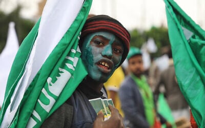 A Houthi supporter paints his face in green and carries a flag during a rally to mark Prophet Muhammad’s birthday, known as Moulid, in Sanaa, Yemen, August 25, 2026. (AP Photo/Osamah Abdulrahman)