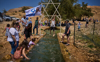 A child climbs on a metal Star of David structure at a spring in Auja, in the Jordan Valley, during Israel’s Independence Day on April 22, 2026, in the West Bank. (AP Photo/Ohad Zwigenberg)