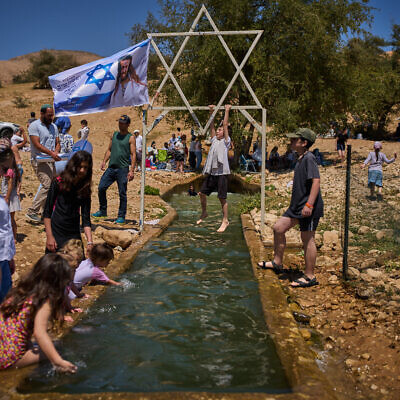 A child climbs on a metal Star of David structure at a spring in Auja, in the Jordan Valley, during Israel’s Independence Day on April 22, 2026, in the West Bank. (AP Photo/Ohad Zwigenberg) A child climbs on a metal Star of David structure at a spring in Auja, in the Jordan Valley, during Israel’s Independence Day on April 22, 2026, in the West Bank. (AP Photo/Ohad Zwigenberg)