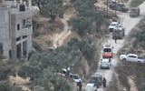 Israeli soldiers surround a building site in the West Bank village of Qusra after it was attacked by settlers, on August 29, 2026. (AP/Majdi Mohammed)