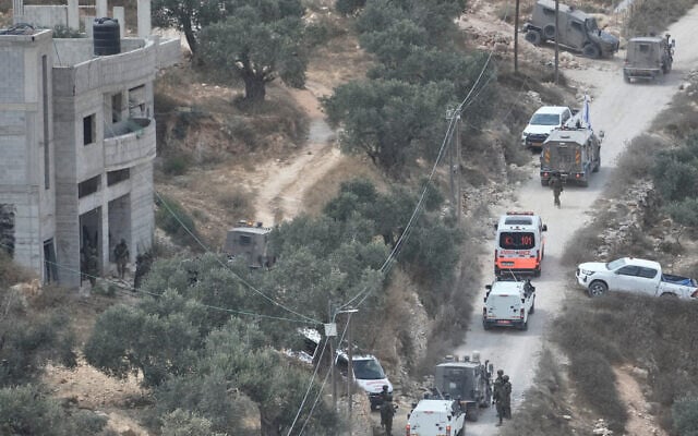 Israeli soldiers surround a building site in the West Bank village of Qusra after it was attacked by settlers, on August 29, 2026. (AP/Majdi Mohammed)