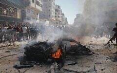 Illustrative: Palestinians gather around the burning wreckage of a car after an Israeli army strike in Gaza City, August 31, 2026. (AP Photo/Yousef Alzanoun)