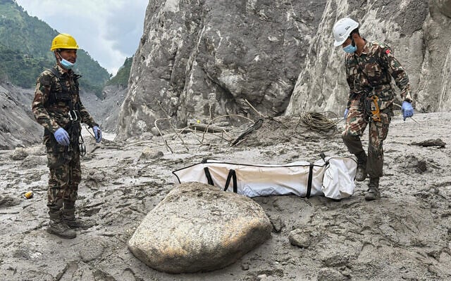 Nepal Army soldiers carry a body of a worker recovered from the site of a hydropower project in Upper Trishuli, Nepal, September 1, 2026. (AP Photo/Kaslai Dine) Nepal Army soldiers carry a body of a worker recovered from the site of a hydropower project in Upper Trishuli, Nepal, September 1, 2026. (AP Photo/Kaslai Dine)