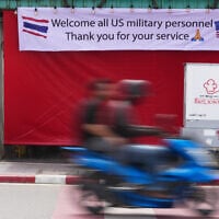 A motorcycle taxi drives past a banner in Pattaya, Thailand, September 1, 2026. (AP/Sakchai Lalit)
