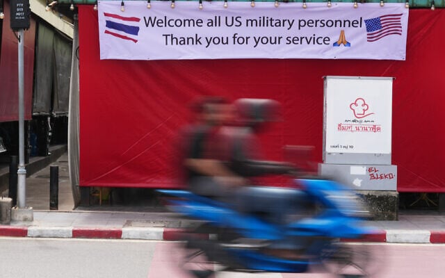 A motorcycle taxi drives past a banner in Pattaya, Thailand, September 1, 2026. (AP/Sakchai Lalit)