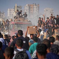 Palestinians ride on a truck loaded with food and humanitarian aid from the World Food Program, after it arrived in the northern Gaza Strip, June 16, 2025. (Jehad Alshrafi/AP)