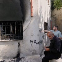 Palestinians check the damage to a mosque that, according to residents, was burned during an attack by Israeli settlers, in the West Bank village of Bazariya, September 1, 2026, as on its wall a Hebrew graffiti reads “Huckabee regards from the terrorists”, referring to the US Ambassador to Israel, Mike Huckabee. (AP Photo/Majdi Mohammed)