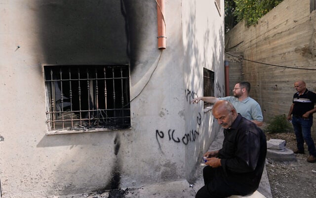 Palestinians check the damage to a mosque that, according to residents, was burned during an attack by Israeli settlers, in the West Bank village of Bazariya, September 1, 2026, as on its wall a Hebrew graffiti reads “Huckabee regards from the terrorists”, referring to the US Ambassador to Israel, Mike Huckabee. (AP Photo/Majdi Mohammed)