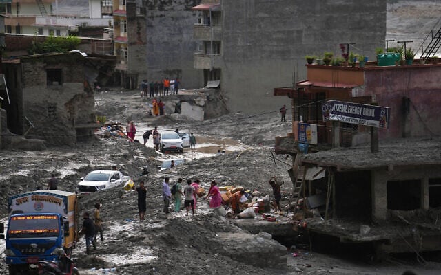 People salvage their belongings from a building damaged by flash flooding in Nuwakot district of Nepal, September 1, 2026. (AP/Rajesh Kumar Singh) People salvage their belongings from a building damaged by flash flooding in Nuwakot district of Nepal, September 1, 2026. (AP/Rajesh Kumar Singh)