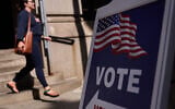 A sign directs voters to an entrance for City Hall during early voting for the Rhode Island primary election, September 2, 2026, in Providence, Rhode Island. (AP Photo/David Goldman)